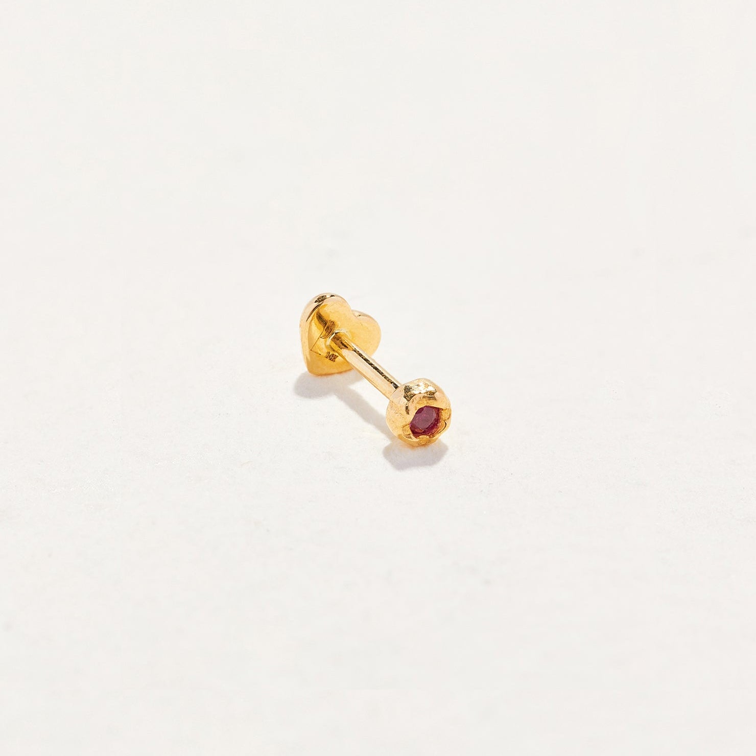 Petite Nugget Stud by Pamela Love – Piercing in #product_material# (#product_color#). petite-ruby-nugget-gold-ruby-red